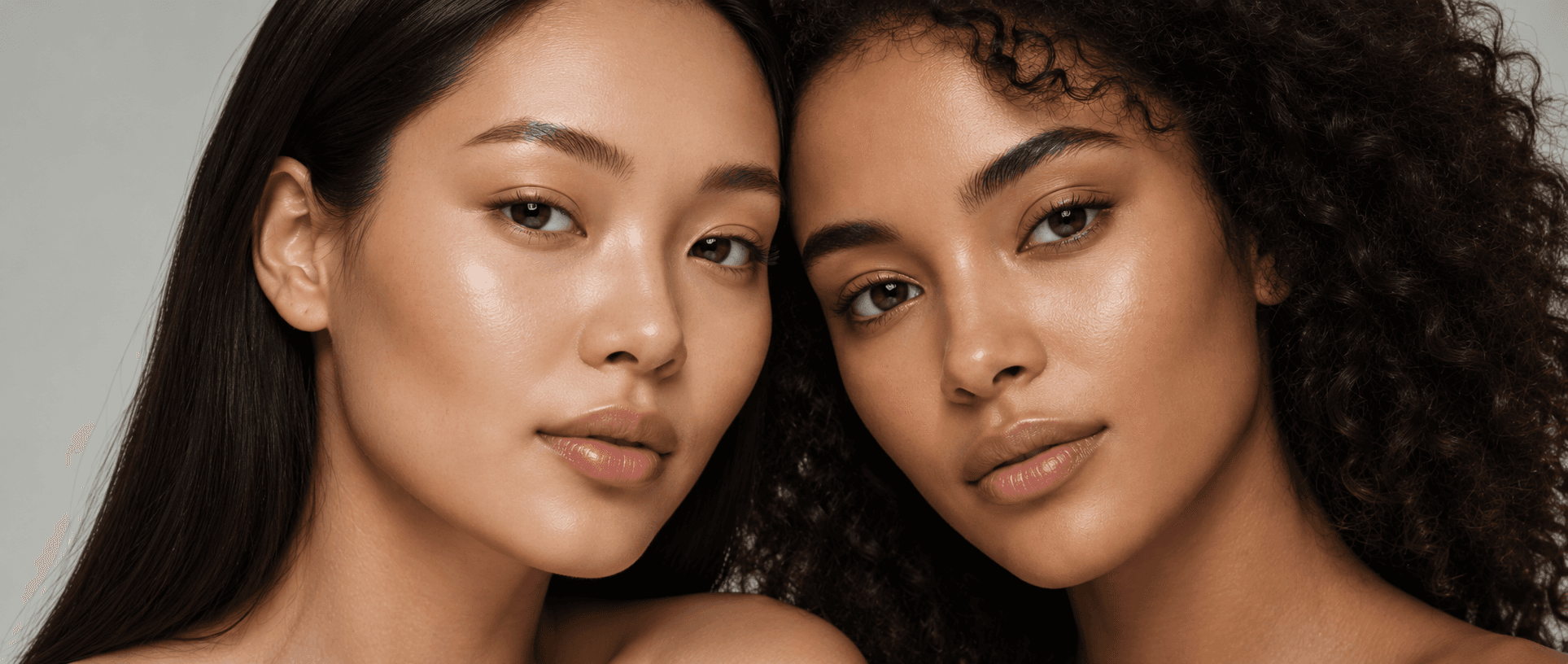 Two women photographed close together, skin clear and unretouched